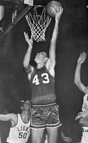 Dunking a basketball.