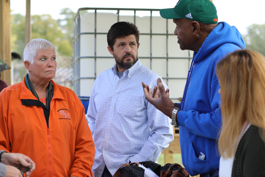 Will Allen speaking with guests at the event.