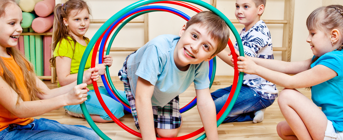 A group of kids play with hula hoops.