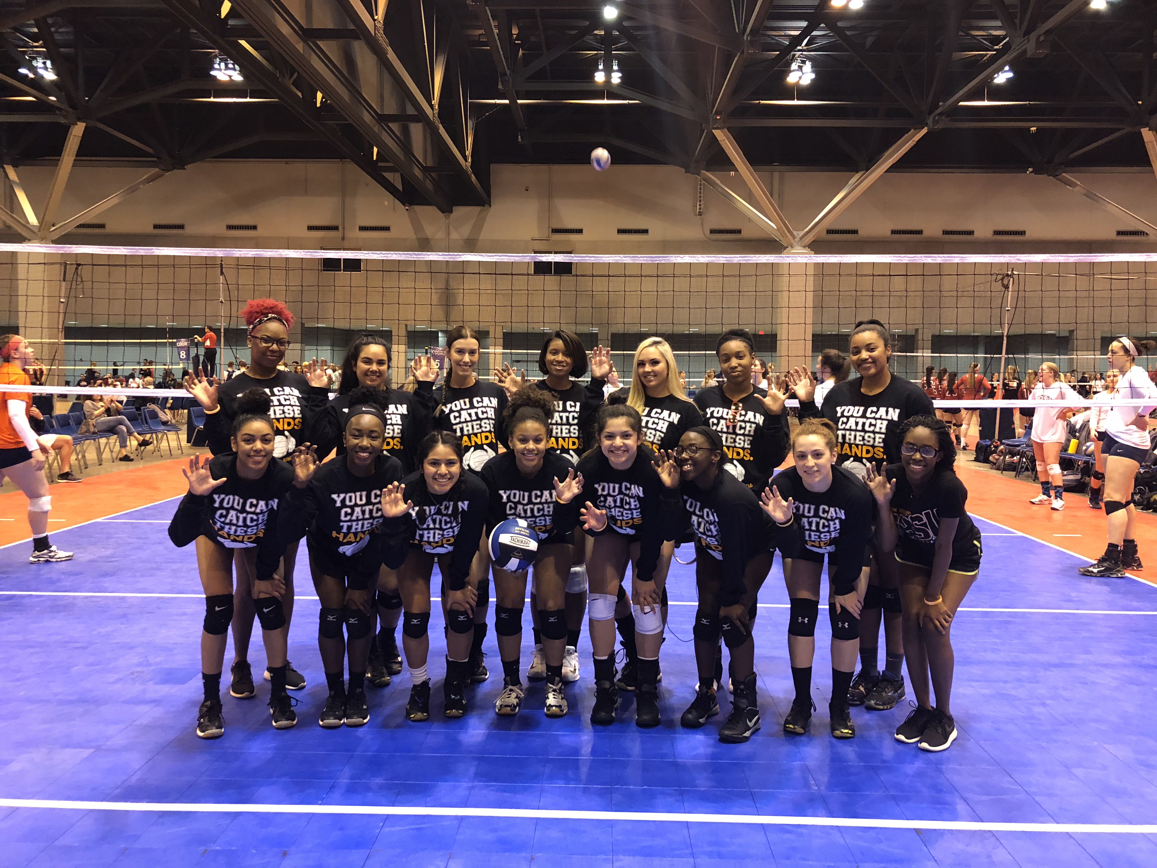 Bearkats posing on a volleyball court.